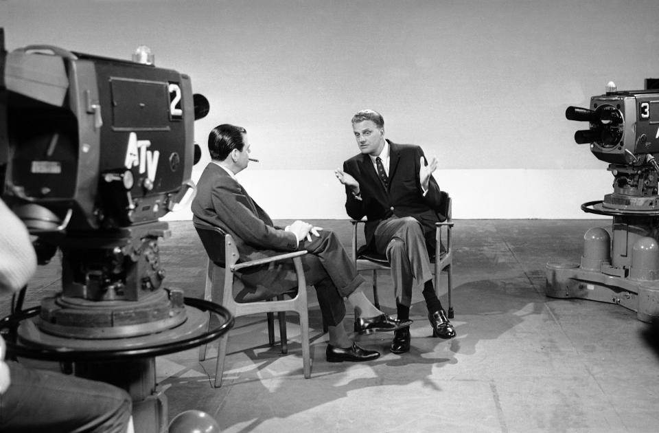 <p>Billy Graham, right, talks to Kenneth Harris at A.T.V. studios at Elstree, near London, May 26, 1966, while recording an interview for the program “About Religion.” (Photo: AP) </p>