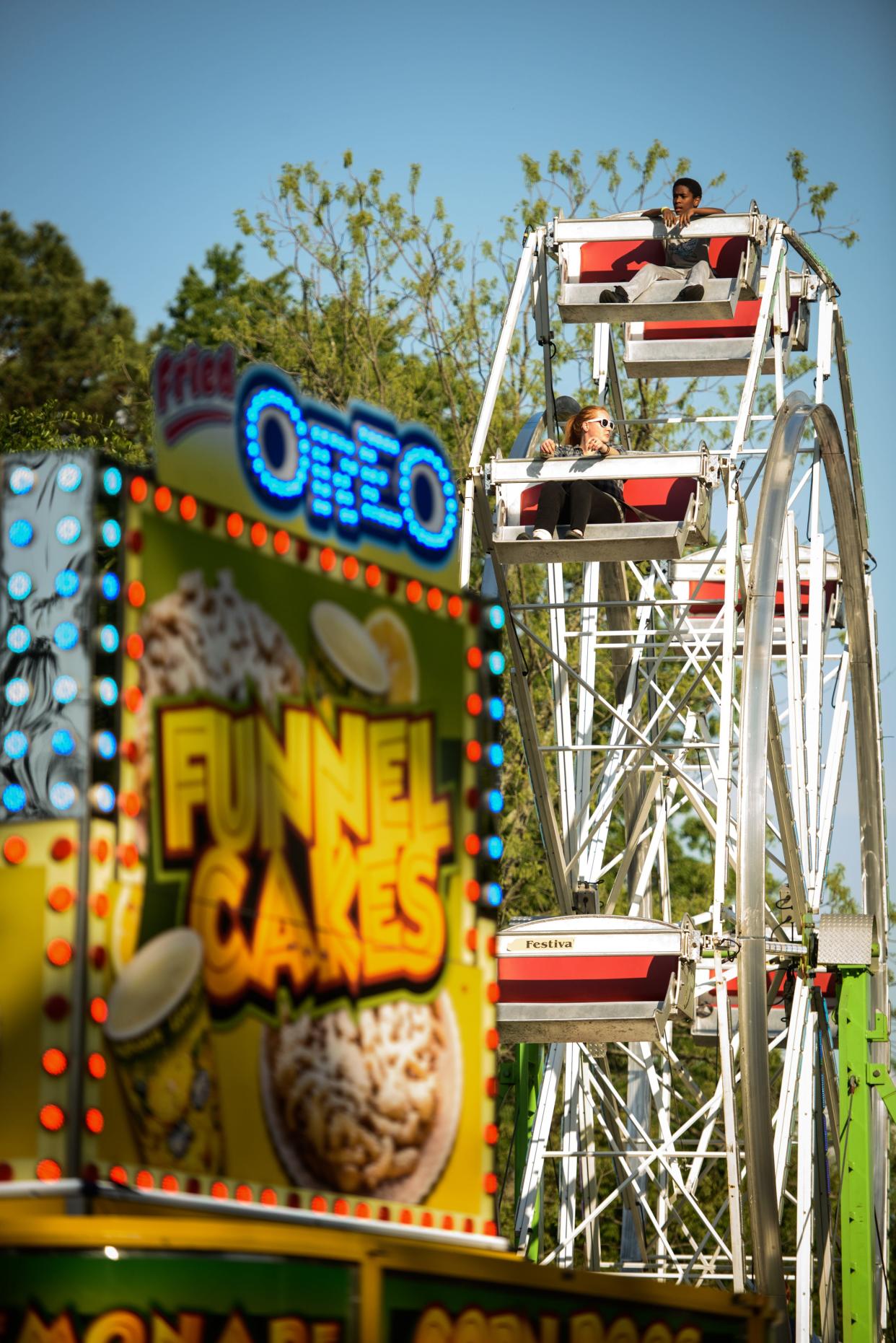 People take a spin on a ferris wheel at the Dogwood Festival on Friday, April, 22, 2022.