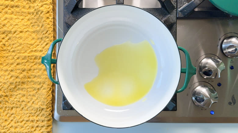 Olive oil heating in pot on stove top