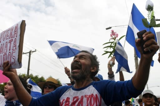 People attend the "Marcha de las Flores" in honor of the children killed during protests