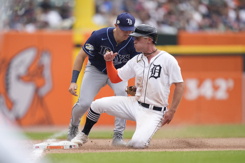 Detroit Tigers designated hitter Kerry Carpenter safely beats the tag of Tampa Bay Rays third baseman Curtis Mead during the fourth inning of a baseball game, Sunday, Aug. 6, 2023, in Detroit. (AP Photo/Carlos Osorio)