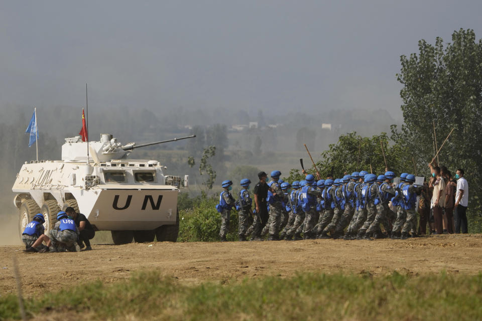 United Nations troops break up fighting in a scenario where participants playing the role of civilians fighting over water resource during the Shared Destiny 2021 drill at the Queshan Peacekeeping Operation training base in Queshan County in central China's Henan province Wednesday, Sept. 15, 2021. Peacekeeping troops from China, Thailand, Mongolia and Pakistan took part in the 10 days long exercise that field reconnaissance, armed escort, response to terrorist attacks, medical evacuation and epidemic control. (AP Photo/Ng Han Guan)