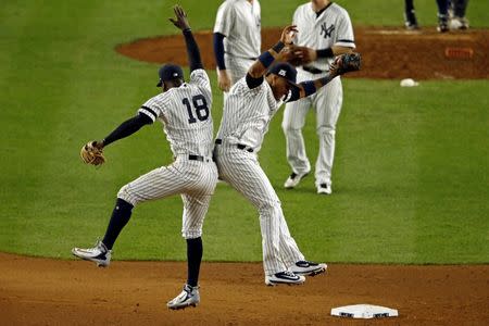 New York Yankees shortstop Didi Gregorius (18) celebrates with New York Yankees second baseman Starlin Castro (14) after beating the Houston Astros in game five of the 2017 ALCS playoff baseball series at Yankee Stadium, Bronx, NY, USA, October 18, 2017. Mandatory Credit: Adam Hunger-USA TODAY Sports