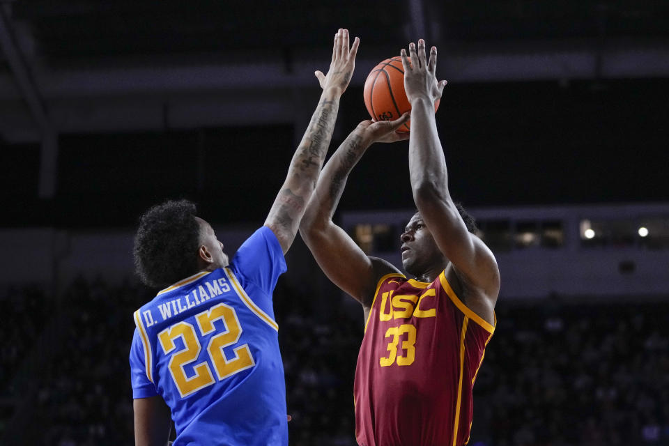 Southern California forward Kijani Wright, right, shoots against UCLA forward Devin Williams during the first half of an NCAA college basketball game, Saturday, Jan. 27, 2024, in Los Angeles. (AP Photo/Ryan Sun)