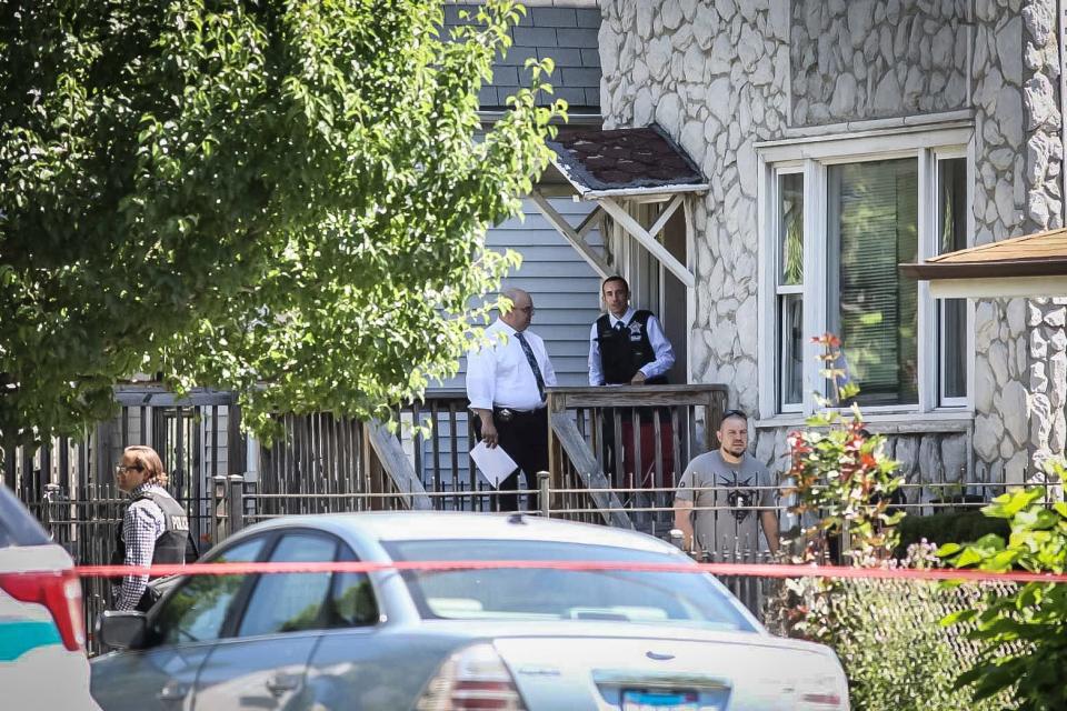 Police investigate outside the scene of a shooting outside a home in Chicago, Tuesday, June 15, 2021. Police say an argument at a house on Chicago's South Side erupted in fatal gunfire, leaving some dead and others injured.