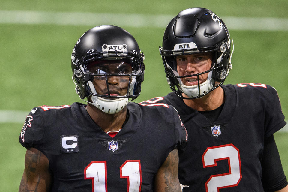 FILE - Atlanta Falcons quarterback Matt Ryan (2) speaks with wide receiver Julio Jones (11) during the second half of an NFL football game against the New Orleans Saints, in Atlanta, in this Sunday, Dec. 6, 2020, file photo. The Atlanta Falcons began their offseason training program Tuesday, May 25, 20921, without longtime star receiver Julio Jones, who apparently has no intention of returning to a rebuilding team that is still struggling to get under the salary cap. (AP Photo/Danny Karnik, FIle)