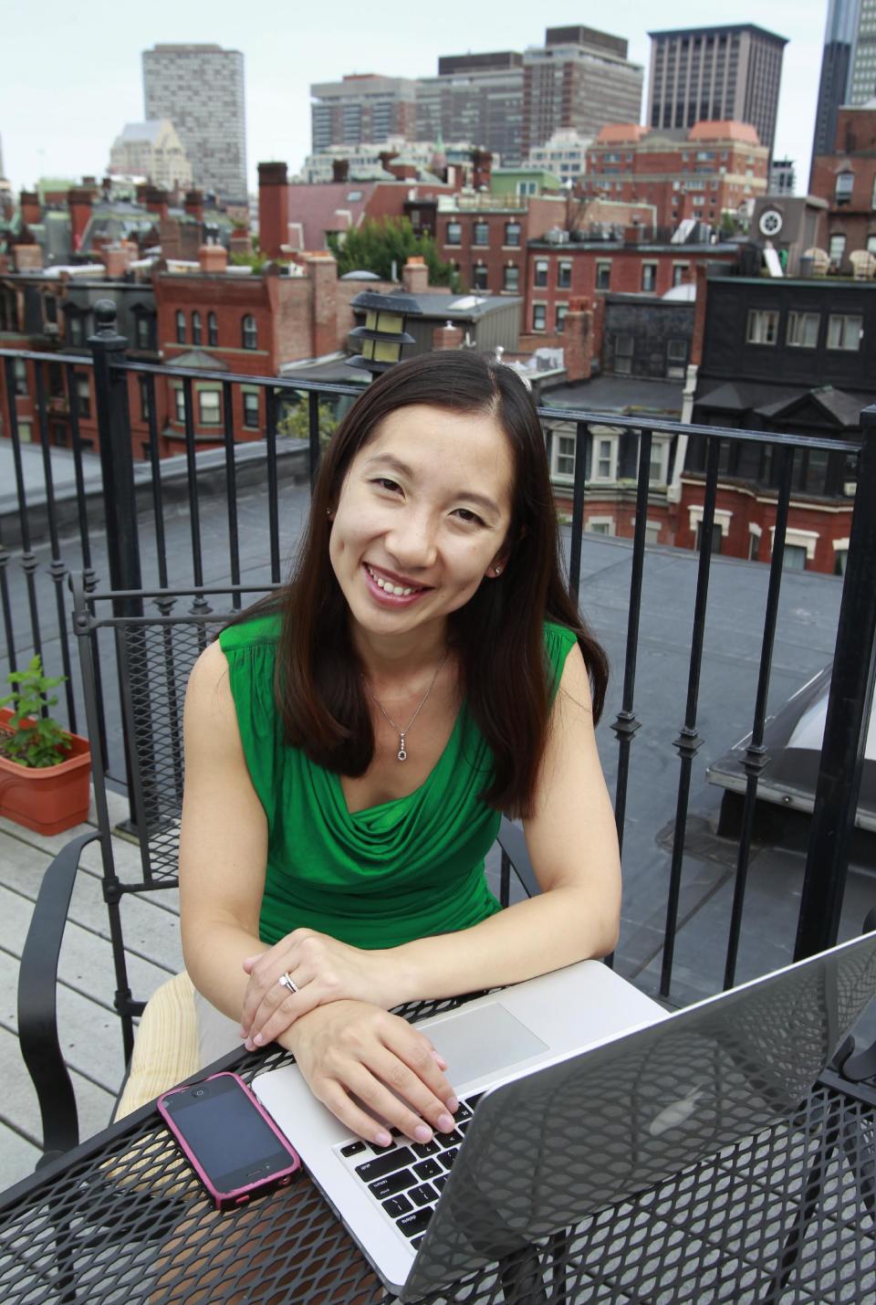 In this Tuesday, Aug. 14, 2012 photo Leana Wen, who is doing her medical residency in emergency medicine at Harvard-affiliated Brigham and Women's Hospital and Massachusetts General Hospital, sits in front of her computer on the rooftop of her apartment in Boston. Wen chose emergency medicine because the hours are more flexible than those of primary care physicians. (AP Photo/Steven Senne)