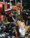 Atlanta Hawks center Clint Capela (15) blocks a shot by Minnesota Timberwolves forward Jaden McDaniels during the second half of an NBA basketball game Monday, Dec. 6, 2021, in Minneapolis. (AP Photo/Craig Lassig)