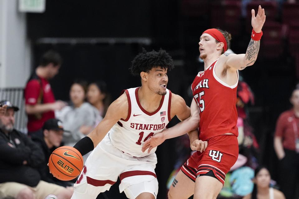 Stanford forward Spencer Jones (14) is defended by Utah guard Gabe Madsen (55) during the first half of an NCAA college basketball game, Sunday, Jan. 14, 2024, in Stanford, Calif. | Godofredo A. Vásquez, Associated Press