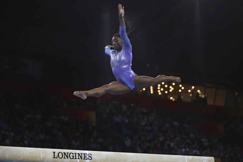 Gold medalist Simone Biles of the United States performs on the balance beam in the women's apparatus finals at the Gymnastics World Championships in Stuttgart, Germany, Sunday, Oct. 13, 2019. (AP Photo/Matthias Schrader)