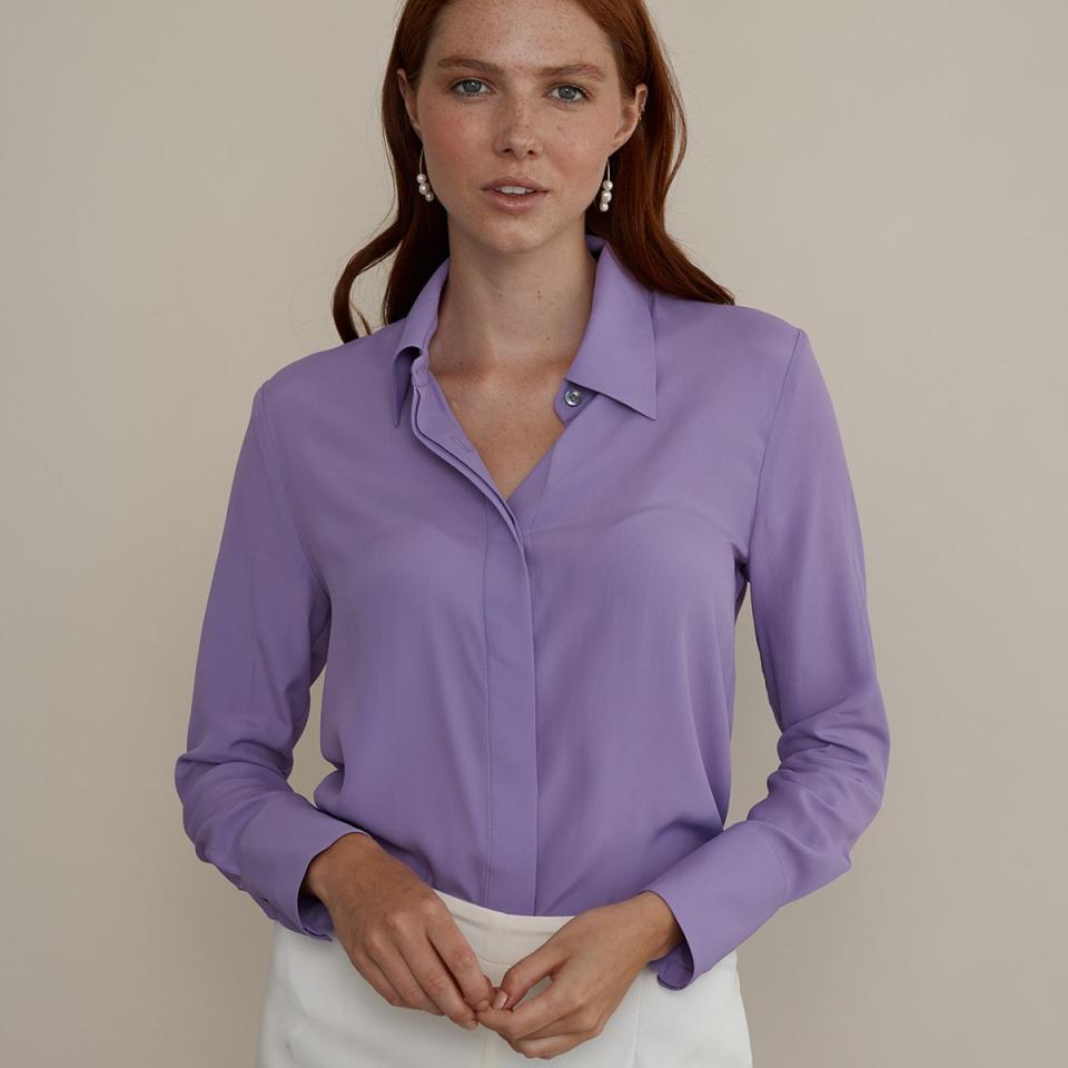 Model wears purple button up silk shirt