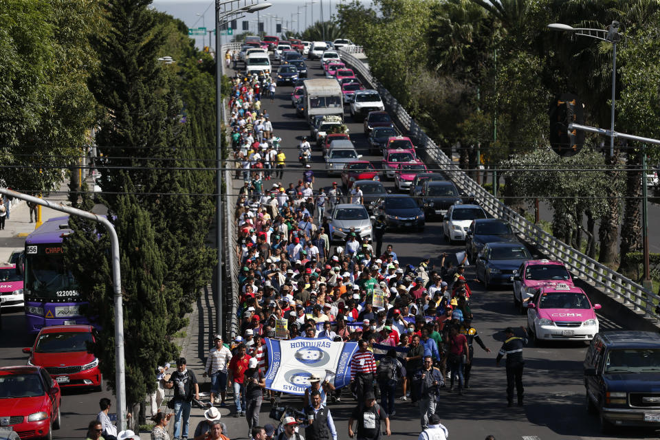 A group of Central American migrants, representing the thousands participating in a caravan trying to reach the U.S. border, undertake an hours-long march to the office of the United Nations' humans rights body in Mexico City, Thursday, Nov. 8, 2018. Members of the caravan which has stopped in Mexico City demanded buses Thursday to take them to the U.S. border, saying it is too cold and dangerous to continue walking and hitchhiking.(AP Photo/Rebecca Blackwell)