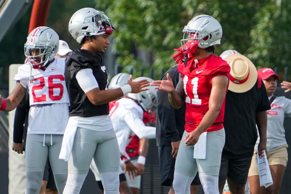Aug 4, 2022; Columbus, OH, USA;  Ohio State Buckeyes quarterback C.J. Stroud (7) does a handshake with wide receiver Jaxon Smith-Njigba (11) during the first fall football practice at the Woody Hayes Athletic Center. Mandatory Credit: Adam Cairns-The Columbus Dispatch