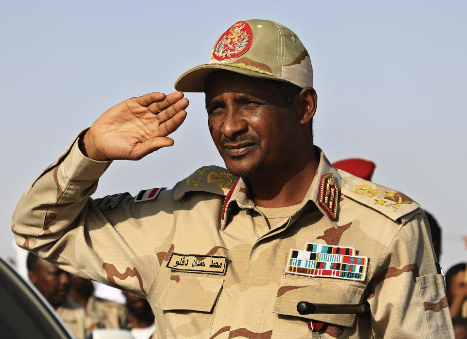 FILE - In this June 15, 2019 file photo, Gen. Mohammed Hamdan Dagalo, the deputy head of the military council, salutes during a rally, in Galawee, northern Sudan. Sudan’s transitional authorities and a rebel faction reached a peace deal, part of government efforts to end the country’s decadeslong civil wars. The government said it signed the deal Tuesday, Dec. 24, 2019, with a faction of the Sudan Revolutionary Front in South Sudan's capital, Juba. The deal could pave the way for other peace agreements with more factions, as well as other rebel groups. (AP Photo, File)