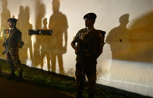 Soldiers stand guard at former president Mahinda Rajapakse's Colombo home after he was controversially sworn in as prime minister