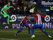 Football Soccer - Atletico Madrid v Eibar - Spanish King's Cup - Vicente Calderon stadium, Madrid, Spain - 19/01/17 - Atletico Madrid's Antoine Griezmann scores his first goal past Eibar's goalkeeper Yoel Rodriguez and Atletico Madrid's Jose Maria Gimenez. REUTERS/Sergio Perez