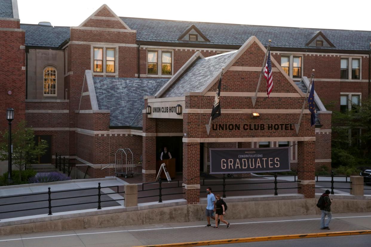 Pedestrians walk past the Purdue Union Club Hotel, Thursday, May 13, 2021 in West Lafayette.