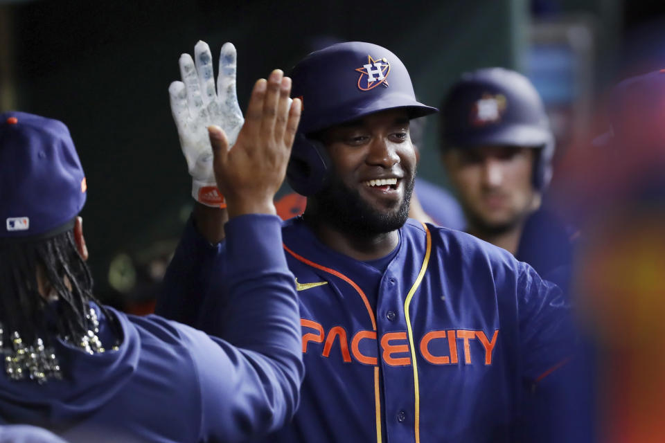 Houston Astros' Yordan Alvarez celebrates after his three-run home run in the dugout during the fifth inning of a baseball game against the Detroit Tigers, Monday, April 3, 2023, in Houston. It was Alvarez's 100th career home run. (AP Photo/Michael Wyke)