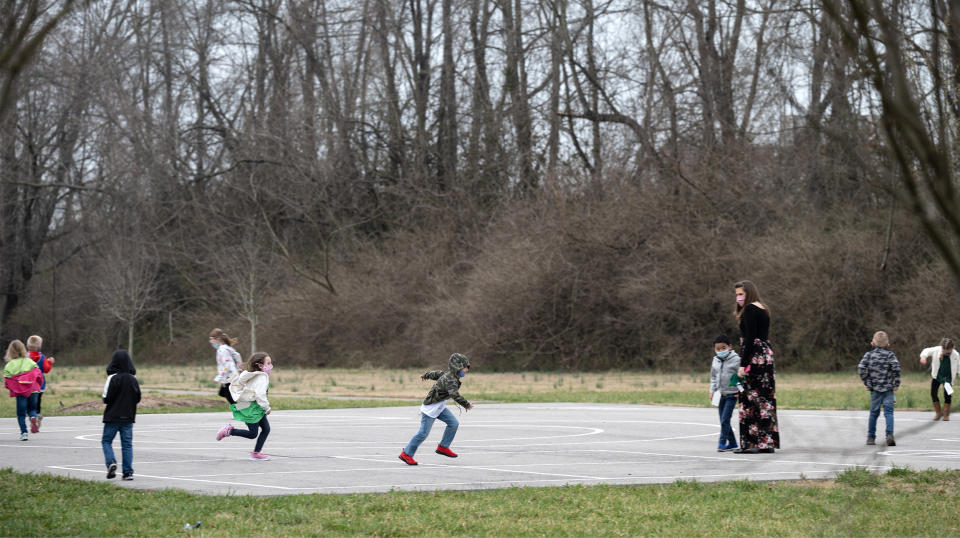 Image: Children playing on a playground. (Jon Cherry / Getty Images file)