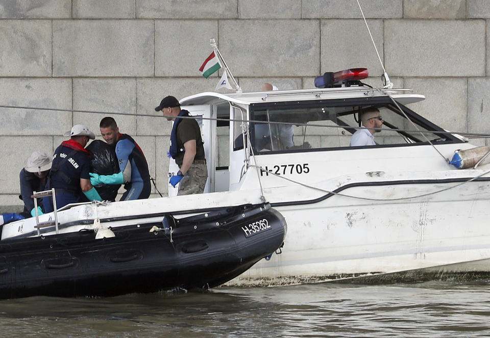 A victim's body is lifted by the rescue workers on the Danube river where a sightseeing boat capsized in Budapest, Hungary, Wednesday, June 5, 2019. Divers and rescue crews slowly are recovering the bodies of a growing number of people killed when a sightseeing boat and a long river cruise ship collided in Hungary's capital. (AP Photo/Laszlo Balogh)