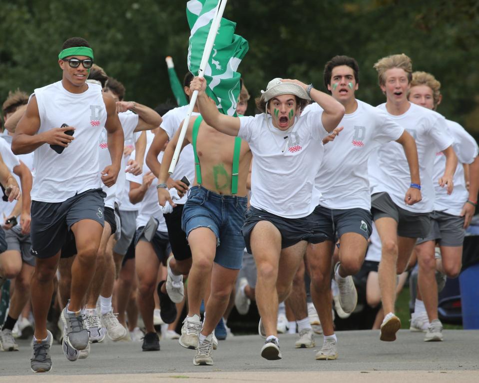 Delbarton students charge onto the football field to support their team prior to the game against Don Bosco on Oct. 14, 2021.