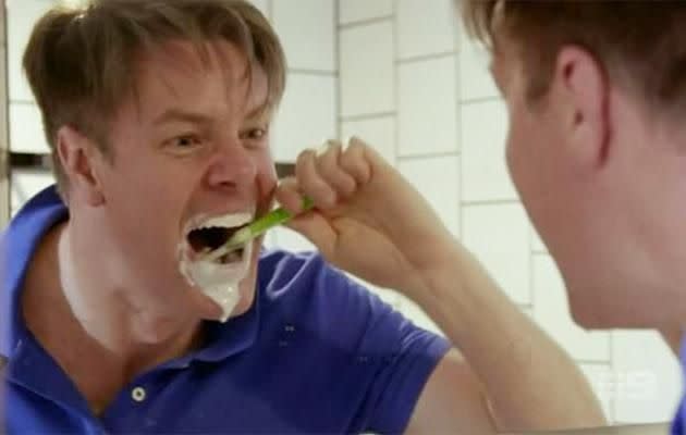 Toothpaste is seen dribbling down his face in the bizarre teeth-brushing scene. Source: Nine