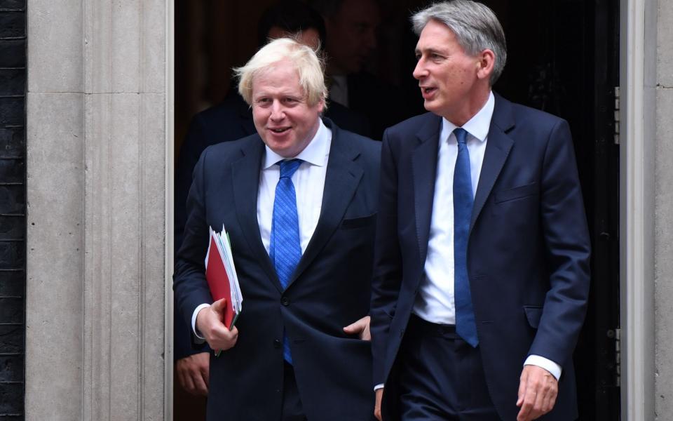 Foreign Secretary Boris Johnson (L) and Chancellor of the Exchequer Philip Hammond - AFP