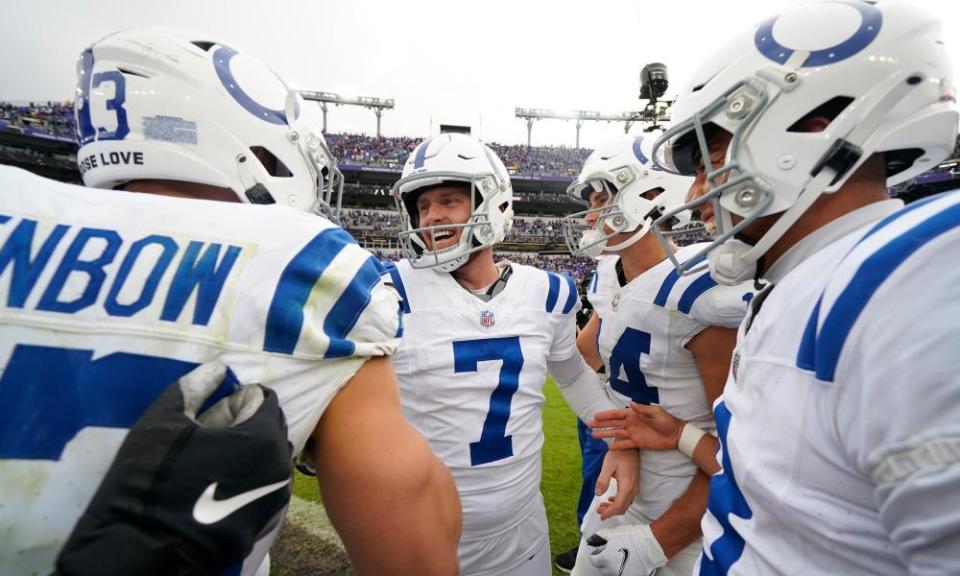 Matt Gay celebrates with teammates after kicking the winning field goal against the Ravens