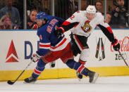 NEW YORK, NY - APRIL 21: Michael Del Zotto #4 of the New York Rangers fights for the puck against Jim O'Brien #42 of the Ottawa Senators in Game Five of the Eastern Conference Quarterfinals during the 2012 NHL Stanley Cup Playoffs at Madison Square Garden on April 21, 2012 in New York City. (Photo by Mike Stobe/Getty Images)