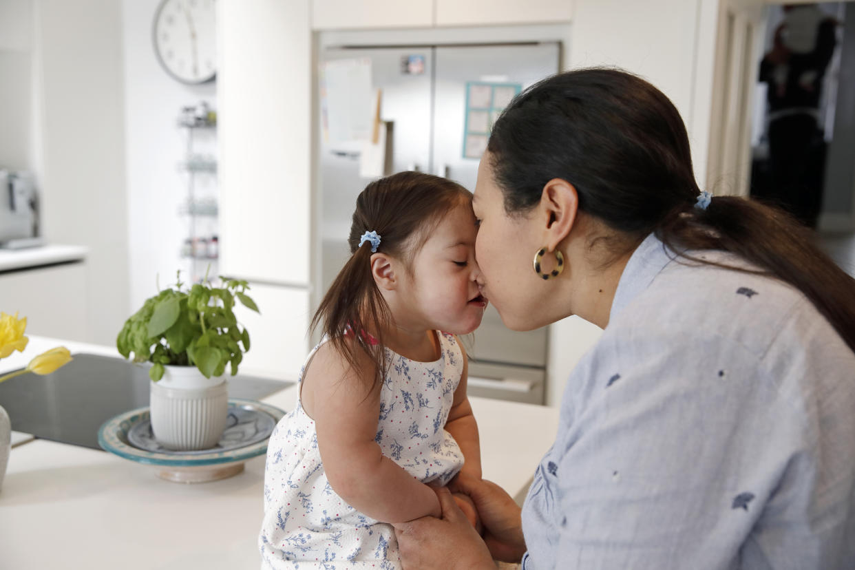 Mother and daughter in kitchen, affectionate, cute, love