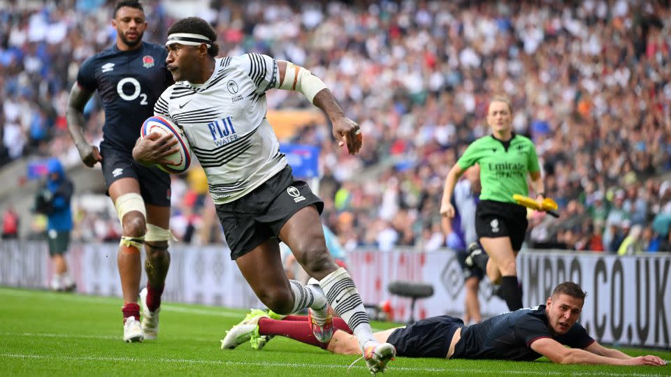 Fiji's Vinaya Habosi runs in a try against England. - Clive Mason/Getty Images