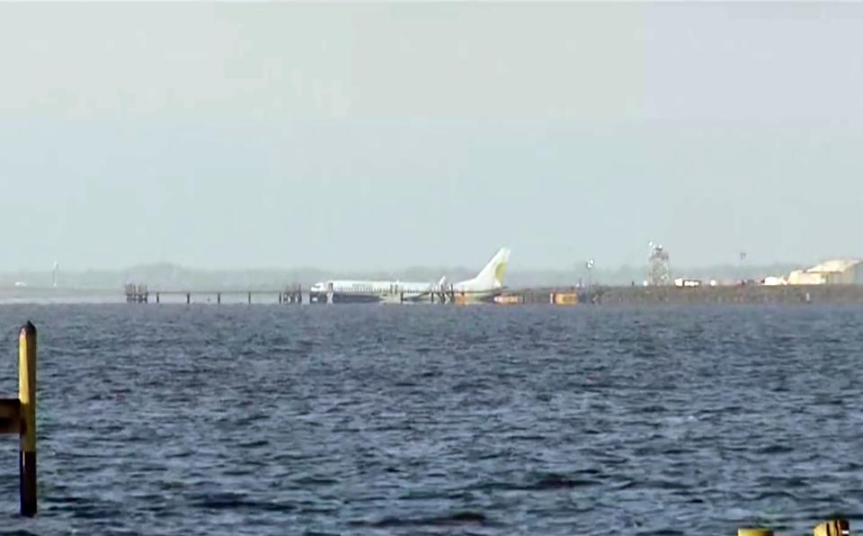 A charter plane carrying 143 people and traveling from Cuba to north Florida sits in a river at the end of a runway, on May 4 in Jacksonville, Florida.