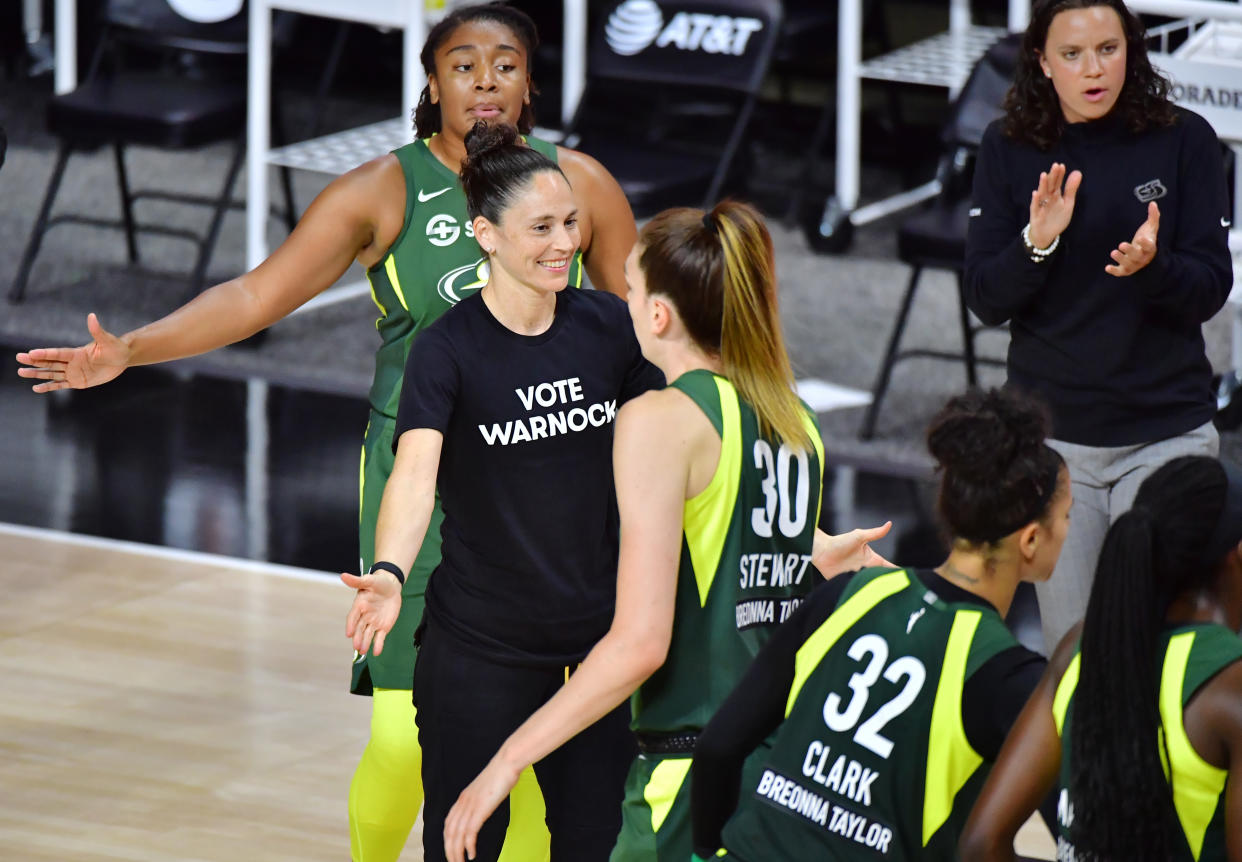Sue Bird in a "Vote Warnock" T-shirts with her Seattle Storm team. 