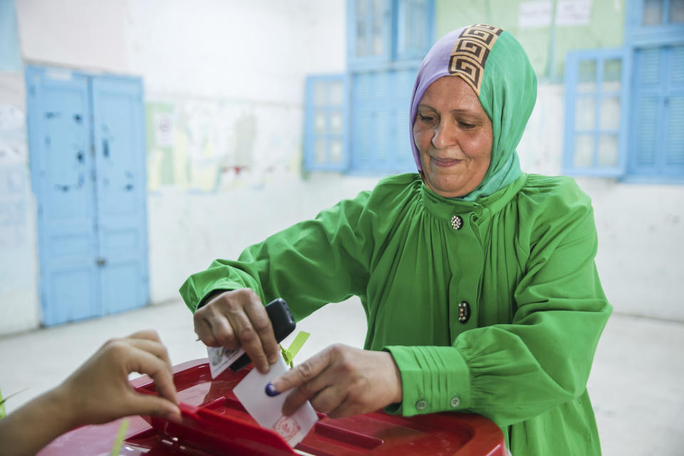 A woman cast her vote at a polling station in Tunis, Tunisia, Monday, July 25, 2022. Tunisians head to the polls Monday to vote on a new constitution. (AP Photo/Hassene Dridi)