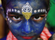 <p>An Indian student who got her face painted with blue color looks at camera ahead of Janmashtami celebrations at a college in Mumbai, India, Aug. 23, 2016. Janmashtami, is an annual celebration of the birth of the Hindu deity Krishna. (Photo: Rafiq Maqbool/AP) </p>
