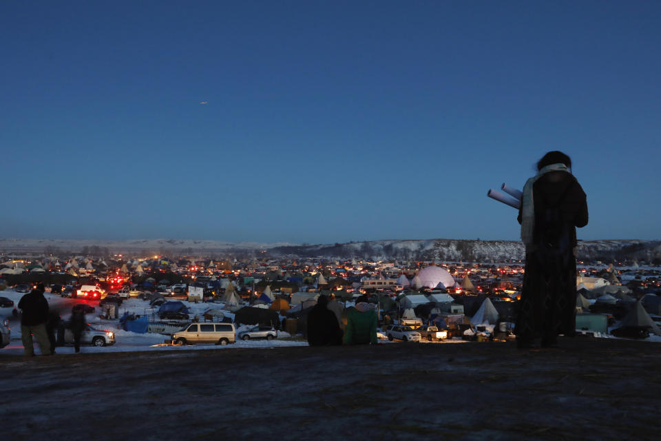 A woman looks out over the Oceti Sakowin camp as activists celebrate.