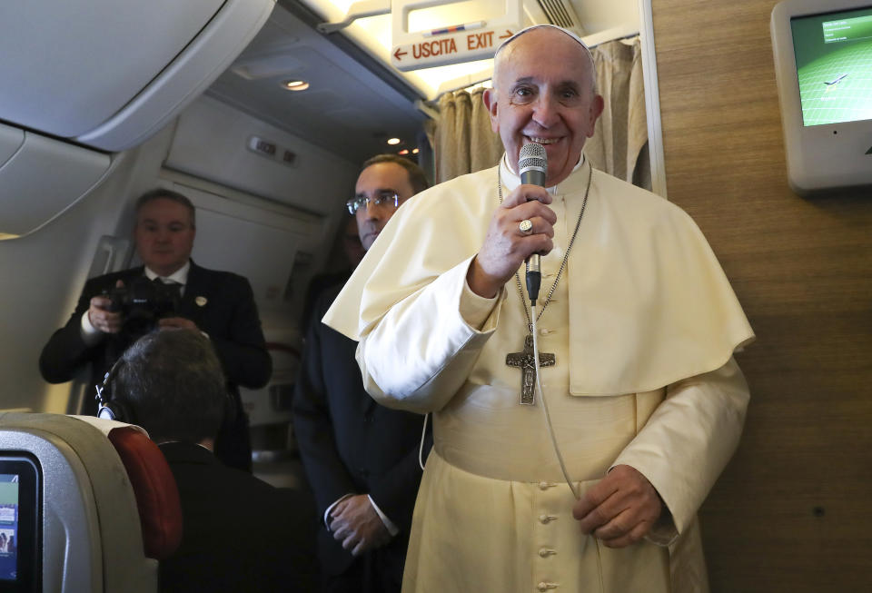 Pope Francis speaks to reporters aboard a plane from Rome to Abu Dhabi, Sunday, Feb. 3, 2019. Francis made an urgent appeal for an end to the humanitarian crisis in Yemen on Sunday as he embarked on the first-ever papal trip to the Arabian Peninsula, where he is seeking to turn a page in Christian-Muslim relations while also ministering to a unique, thriving island of Catholicism. (Tony Gentile/Pool photo via AP)