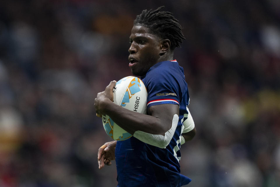 France's Andy Timo scores a try against the United States during bronze-medal Vancouver Sevens rugby match action in Vancouver, British Columbia, Sunday, Feb. 25, 2024. (Ethan Cairns/The Canadian Press via AP)