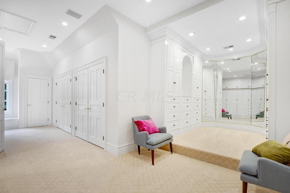 The owner's suite in a Hoover Reservoir home includes a three-sided mirror in the dressing room.