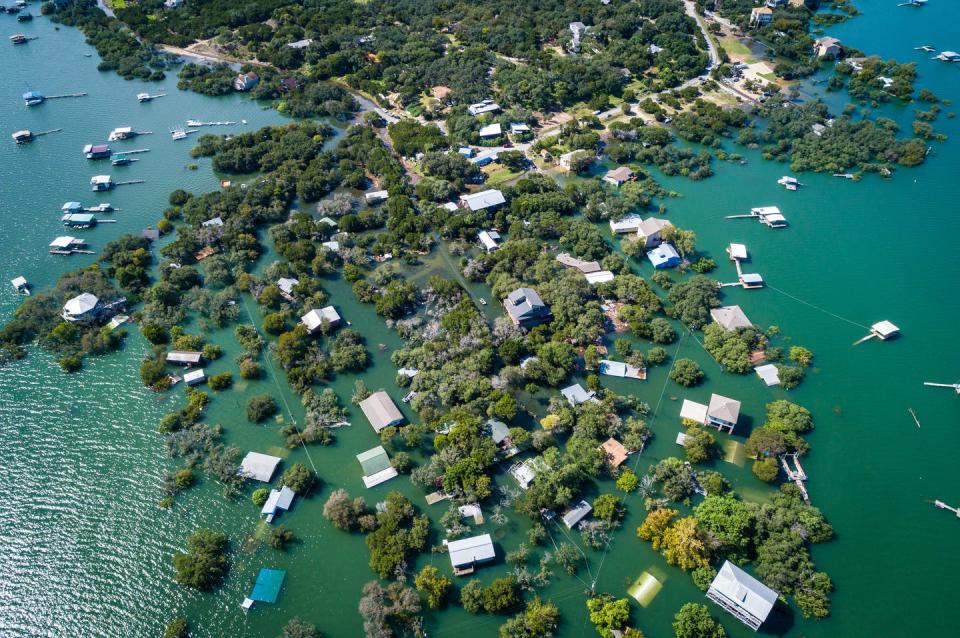 <span class="caption">Low-lying communities near rivers and bays face increasing risk of flooding.</span> <span class="attribution"><a class="link " href="https://www.gettyimages.com/detail/photo/climate-change-flooding-destroyed-entire-royalty-free-image/1207848084?adppopup=true" rel="nofollow noopener" target="_blank" data-ylk="slk:RoschetzkyIstockPhoto;elm:context_link;itc:0;sec:content-canvas"> RoschetzkyIstockPhoto</a></span>