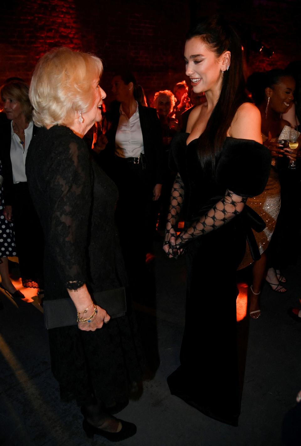 Camilla, Queen Consort meets singer Dua Lipa at the 2022 Booker Prize for Fiction ceremony at the Roundhouse, on October 17, 2022, in London, England.