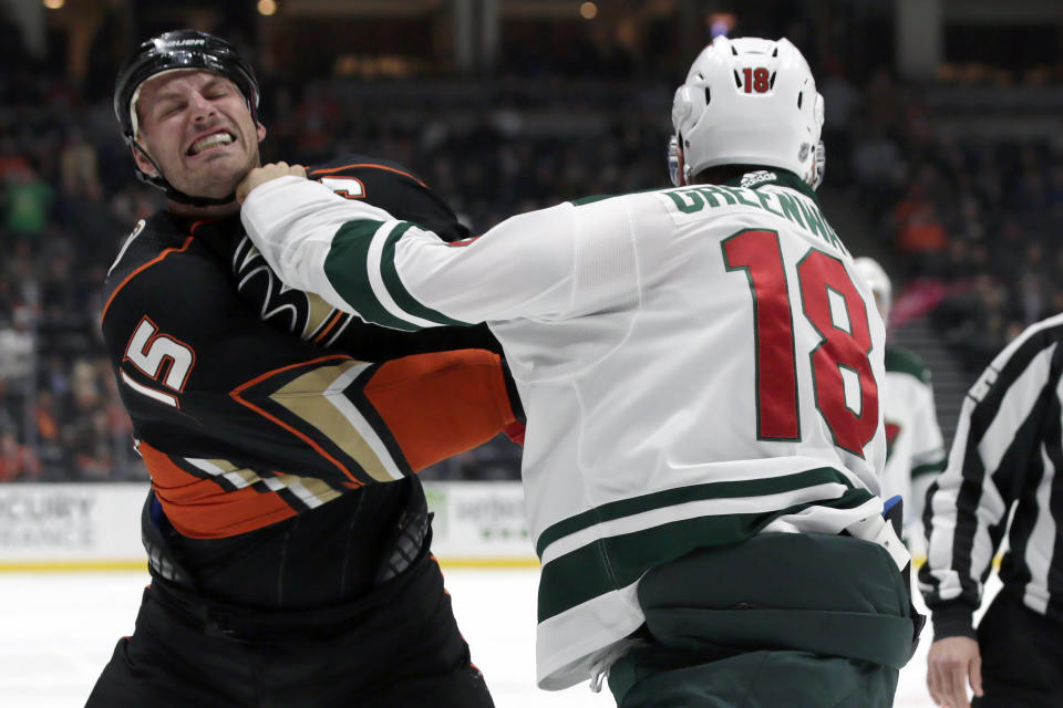 Anaheim Ducks center Ryan Getzlaf, left, exchanges hits with Minnesota Wild left wing Jordan Greenway, right, in a fight during the first period of an NHL hockey game in Anaheim, Calif., Sunday, March 8, 2020. (AP Photo/Alex Gallardo)