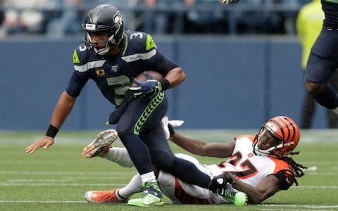 Seattle Seahawks quarterback Russell Wilson is sacked by Cincinnati Bengals cornerback Dre Kirkpatrick, right, during the second half of an NFL football game - Credit: AP