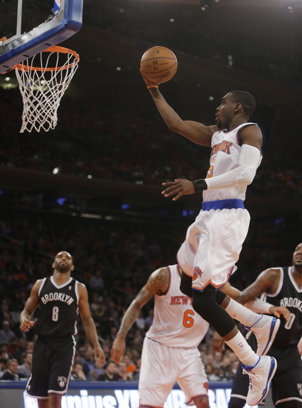 New York Knicks' Tim Hardaway Jr. (5) drives past Brooklyn Nets' Alan Anderson (6) during the first half of an NBA basketball game Wednesday, April 2, 2014, in New York. (AP Photo/Frank Franklin II)