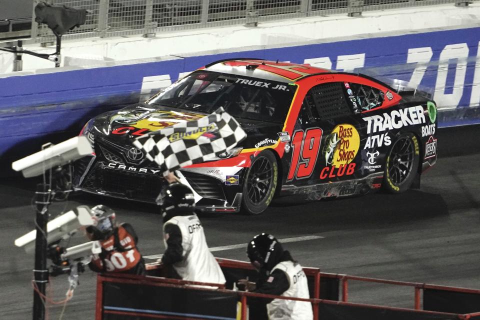 NASCAR Cup Series driver Martin Truex Jr. (19) takes the checkers flag to win the Busch Light Clash NASCAR exhibition auto race at Los Angeles Memorial Coliseum Sunday, Feb. 5, 2023, in Los Angeles. (AP Photo/Mark J. Terrill)