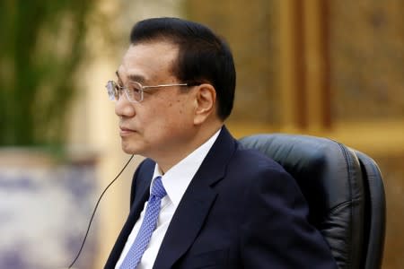 Chinese Premier Li Keqiang attends a meeting at the Great Hall of the People in Beijing