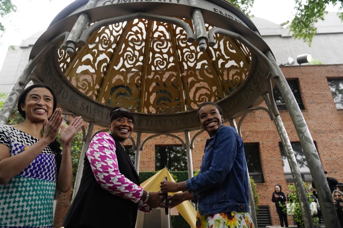 (L-R) Artist Saya Woolfalk, the Rev. Bernice King and Yolanda Renee King stand underneath the Coretta Scott King Peace and Meditation Garden and monument, which was dedicated on April 27, 2023 at The King Center in Atlanta. (AP Photo/Brynn Anderson)