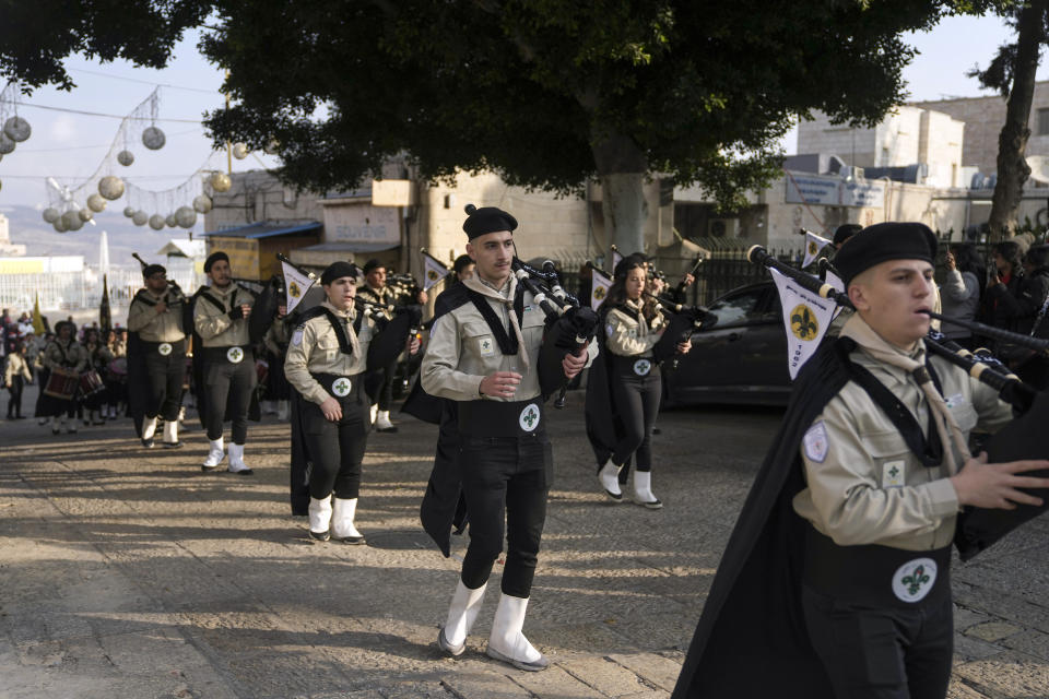 Palestinian scouts march during Christmas parade towards the Church of the Nativity, traditionally believed to be the birthplace of Jesus Christ, in the West Bank town of Bethlehem, Saturday, Dec. 24, 2022. (AP Photo/Mahmoud Illean)