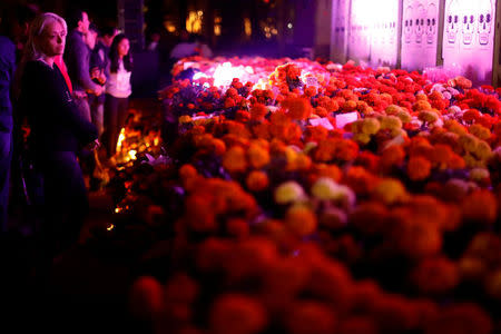 People meet in front of a floral offering for the victims who died in the September 19 earthquake as part of Day of the Dead celebrations at Mexico park in Mexico City, Mexico, November 1, 2017. REUTERS/Edgard Garrido