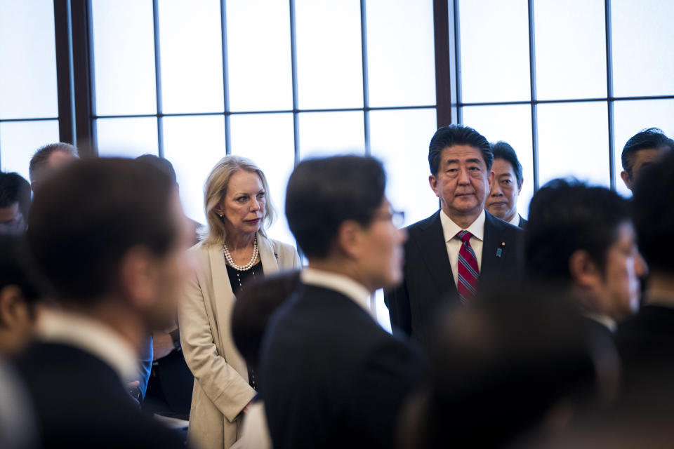 Japan's Prime Minister Shinzo Abe, center right, and Mary Jean Eisenhower, center left, granddaughter of former U.S. President Dwight Eisenhower attend the 60th anniversary commemorative reception of the signing of the Japan-US security treaty at Sunday, Jan. 19, 2020. (Behrouz Mehri/Pool Photo via AP)